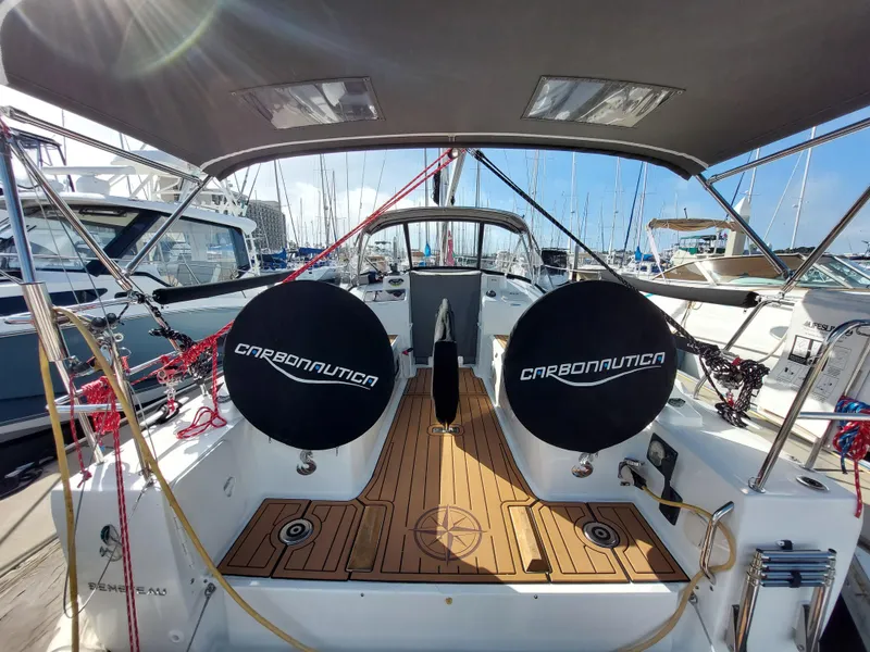 Slide: The Image of Beneteau Oceanis 30.1 sailboat cockpit with dual steering wheels, docked at marina, 2020 model. - 21