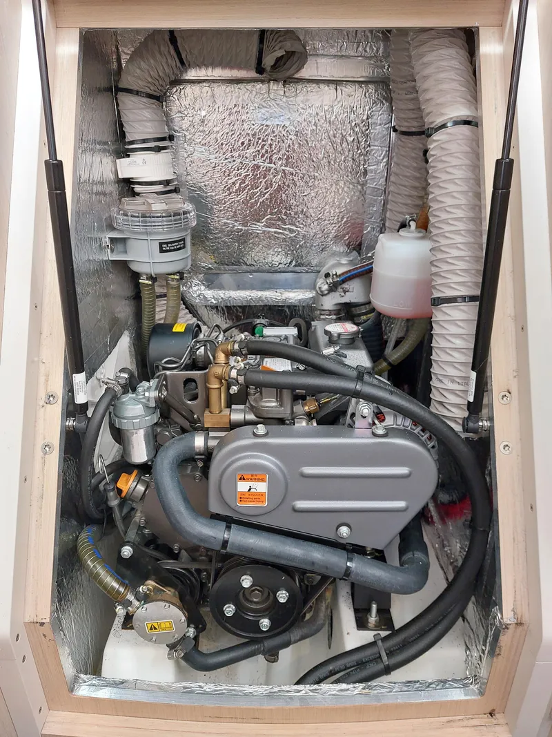 Slide: The Image of Engine compartment of a 2020 Beneteau Oceanis 30.1 sailboat, showcasing mechanical components. - 23