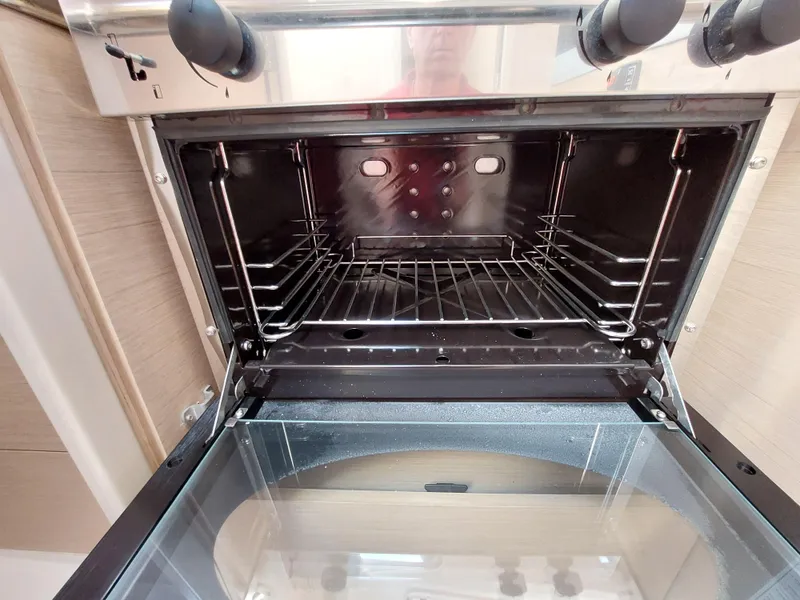 Slide: The Image of Open oven inside a 2020 Beneteau Oceanis 30.1 yacht kitchen. - 28
