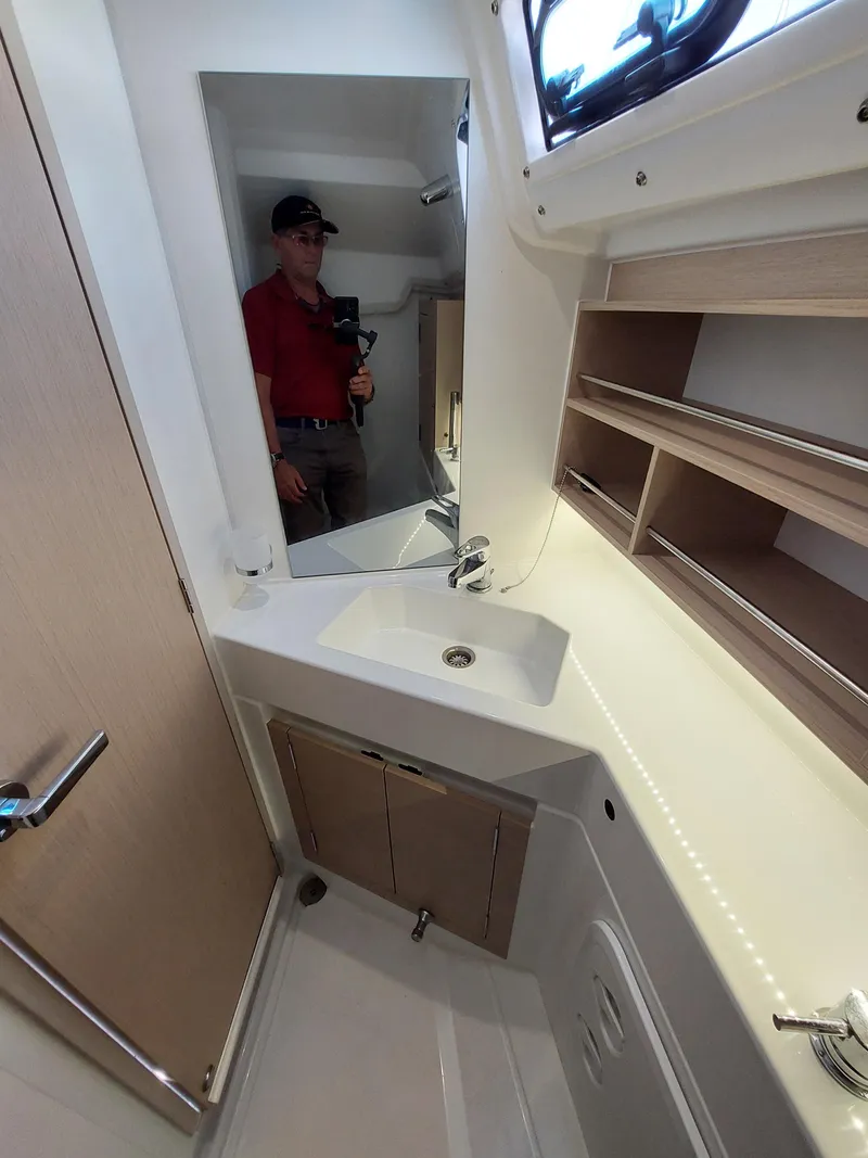 Slide: The Image of Interior of 2020 Beneteau Oceanis 30.1 yacht bathroom with sink and mirror. - 32