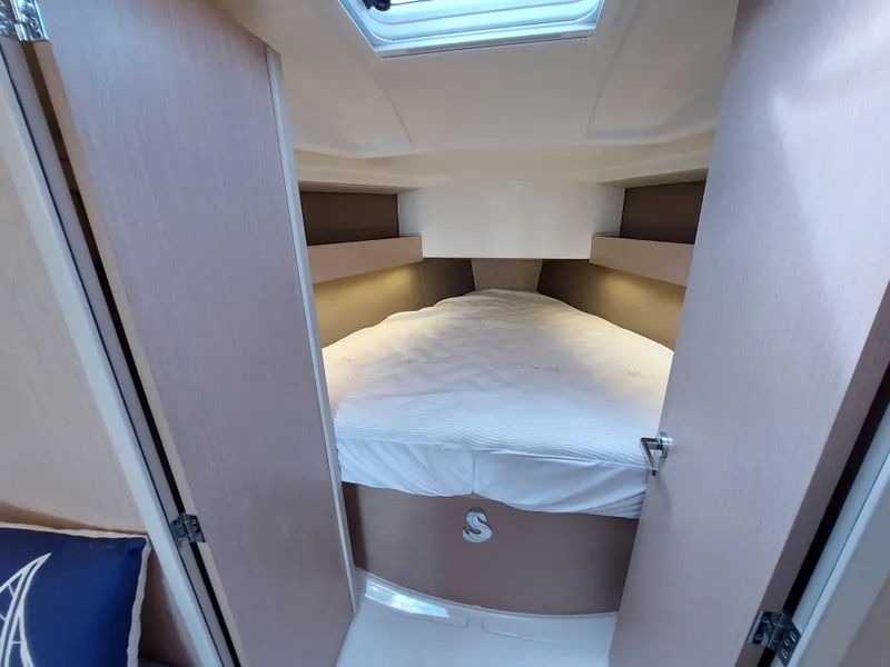 Slide: The Image of Cozy cabin interior of 2020 Beneteau Oceanis 30.1 sailboat with comfortable bedding. - 35