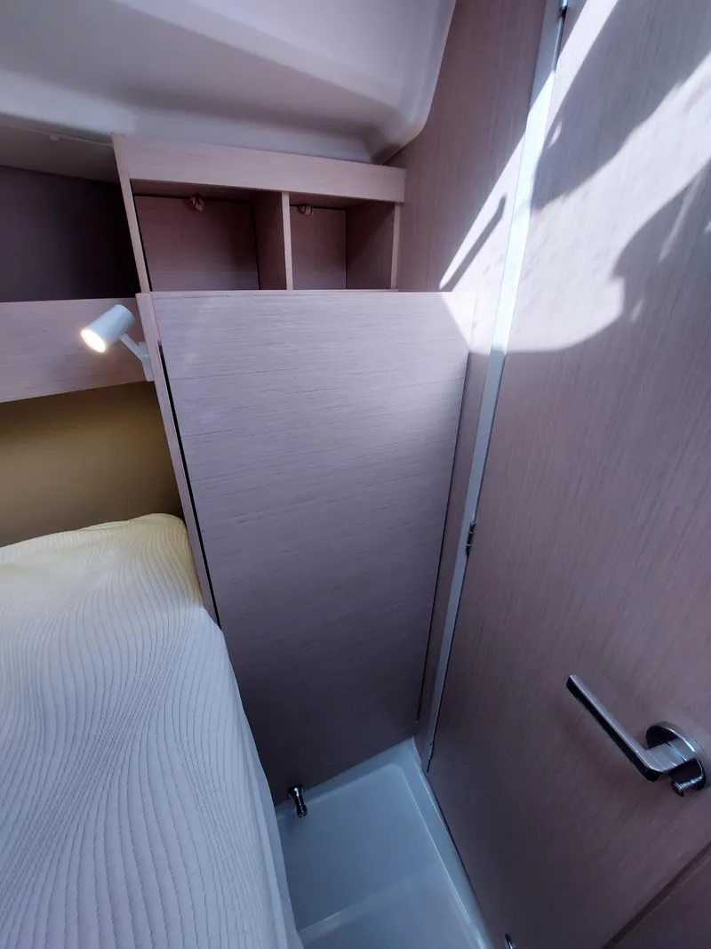 Slide: The Image of Interior of 2020 Beneteau Oceanis 30.1 yacht, featuring compact cabin space. - 38