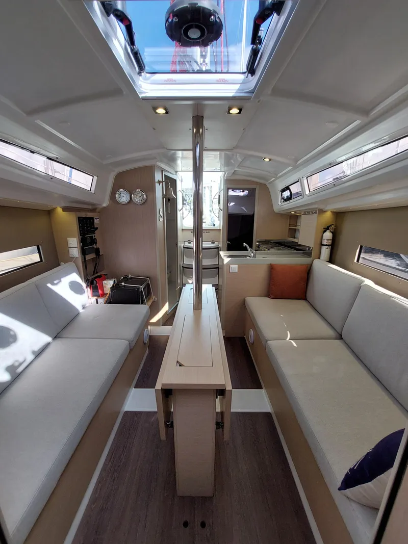 Slide: The Image of Interior of 2020 Beneteau Oceanis 30.1 sailboat, featuring modern seating and skylight. - 41
