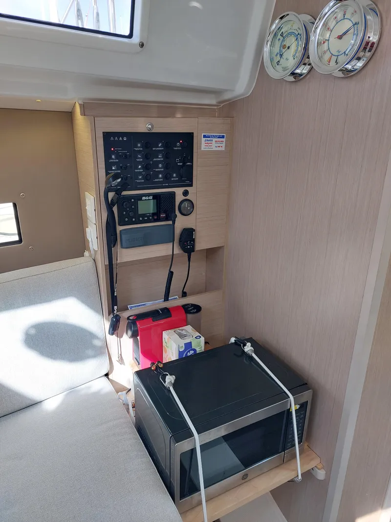 Slide: The Image of Interior of 2020 Beneteau Oceanis 30.1 yacht with control panel and microwave. - 42