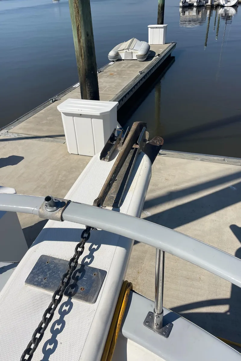 Slide: The Image of 1982 Albin 43 boat docked at a marina with calm water and clear skies. - 11