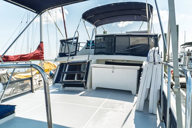 Slide: The Image of 1982 Albin 43 yacht deck with canopy, docked at marina under clear sky. - 17