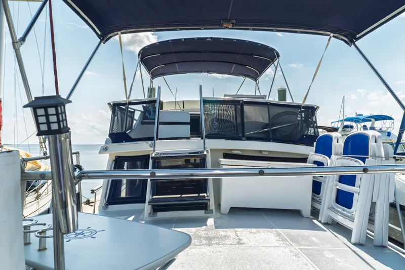 Slide: The Image of 1982 Albin 43 yacht deck with seating and canopy under clear sky. - 18