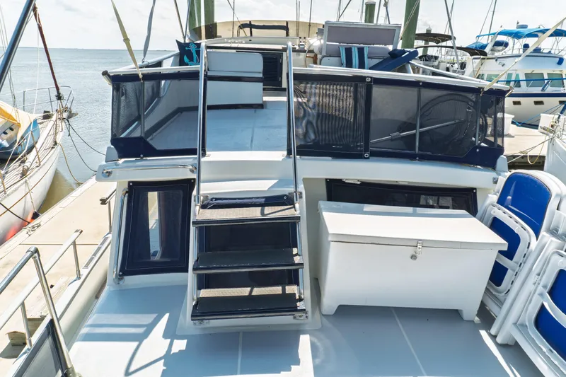 Slide: The Image of 1982 Albin 43 yacht deck with stairs, storage, and seating at marina. - 20