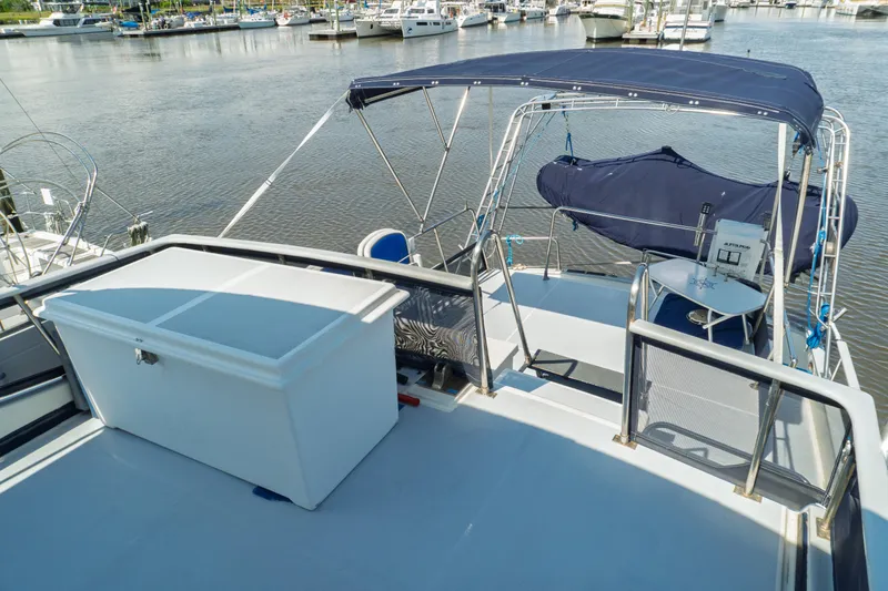 Slide: The Image of 1982 Albin 43 yacht deck with seating and storage, docked at a marina. - 21
