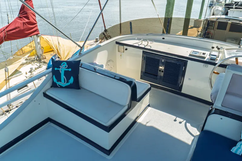 Slide: The Image of 1982 Albin 43 yacht cockpit with nautical-themed cushion and steering wheel. - 23