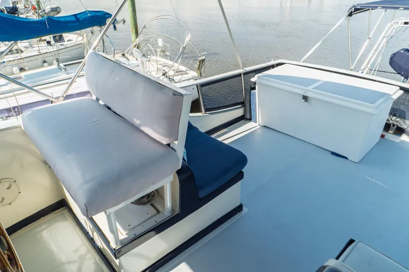 Slide: The Image of 1982 Albin 43 yacht deck with cushioned seating and storage box. - 25