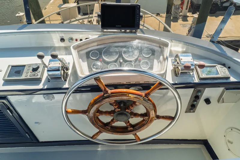 Slide: The Image of 1982 Albin 43 yacht helm with wooden wheel and navigation instruments. - 26