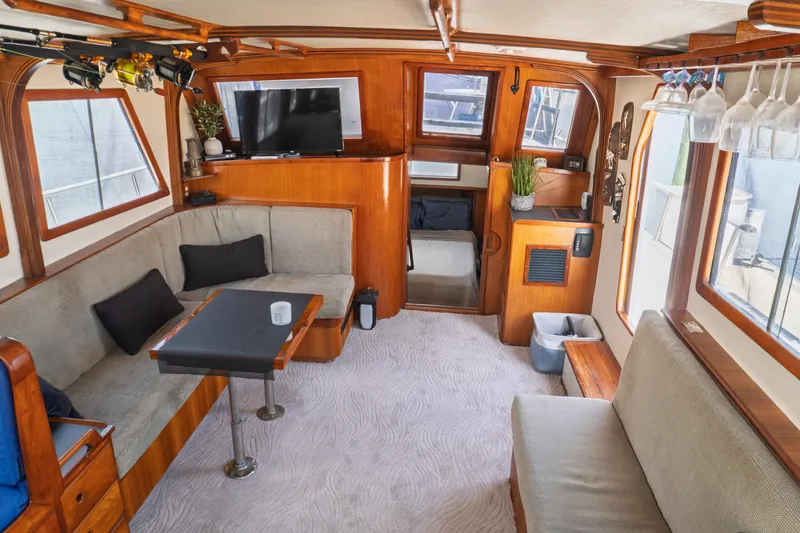 Slide: The Image of Interior of 1982 Albin 43 yacht with cozy seating, table, and TV. - 33