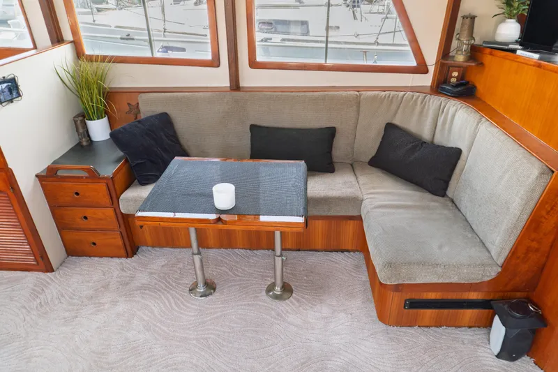 Slide: The Image of Cozy interior of 1982 Albin 43 yacht with cushioned seating and wooden accents. - 35