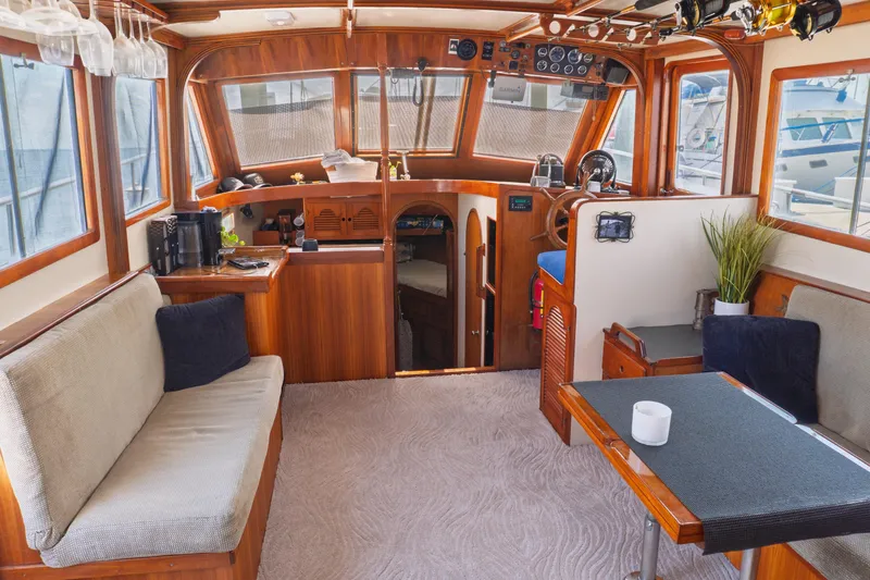 Slide: The Image of Interior of 1982 Albin 43 boat with wooden furnishings and cozy seating area. - 37