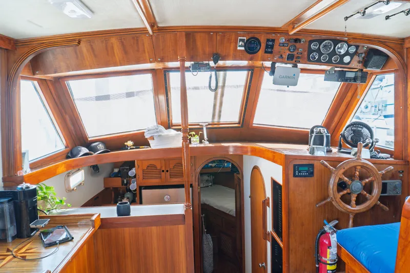 Slide: The Image of Interior of 1982 Albin 43 boat with wooden helm, gauges, and cozy cabin space. - 39