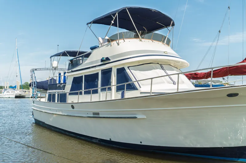 Slide: The Image of 1982 Albin 43 yacht docked in a marina under a clear blue sky. - 4