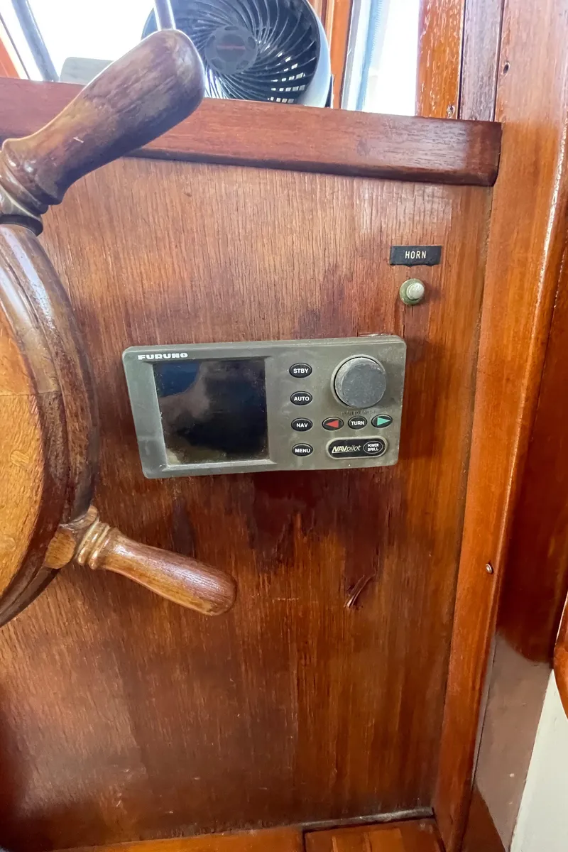 Slide: The Image of Wooden helm with navigation controls on a 1982 Albin 43 boat. - 43