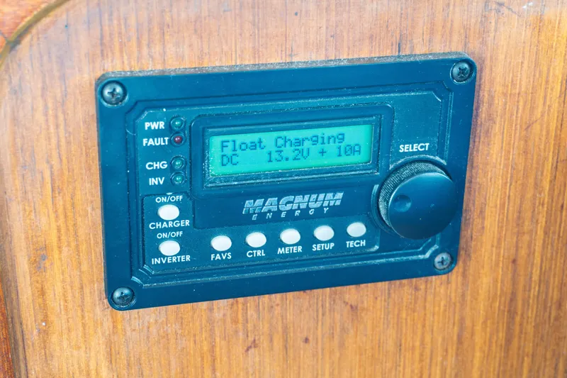 Slide: The Image of Magnum Energy charger display on 1982 Albin 43, showing float charging status. - 44
