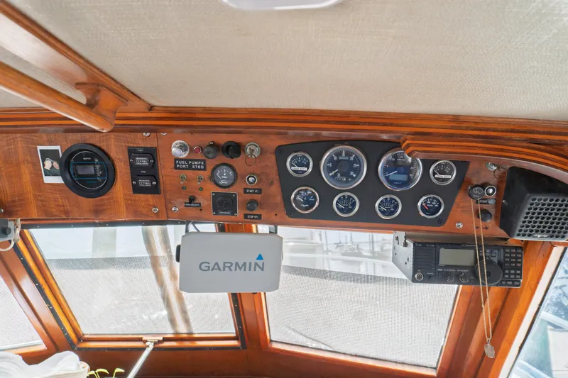 Slide: The Image of 1982 Albin 43 boat dashboard with gauges, Garmin device, and radio equipment. - 45