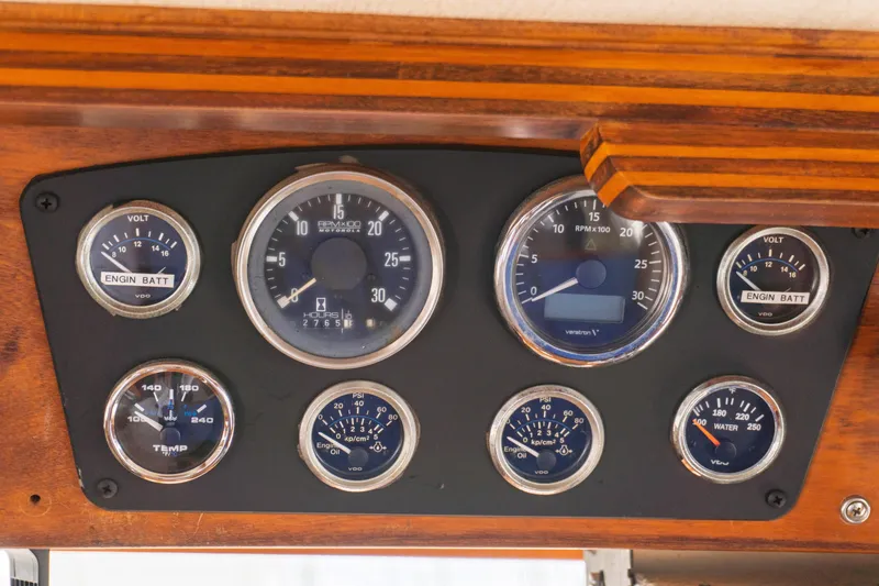 Slide: The Image of 1982 Albin 43 dashboard with gauges for voltage, RPM, temperature, and pressure. - 48