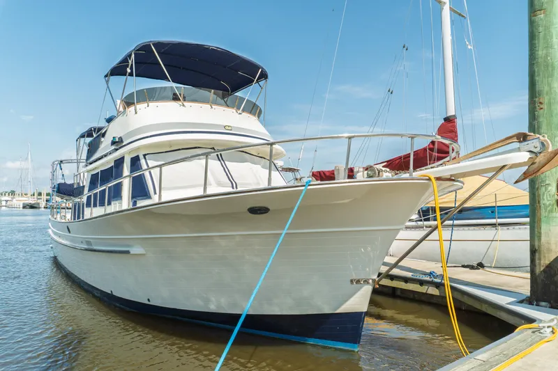 Slide: The Image of 1982 Albin 43 yacht docked in marina under clear blue sky. - 5