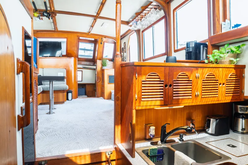 Slide: The Image of Interior of a 1982 Albin 43 boat with wooden cabinetry and modern amenities. - 54