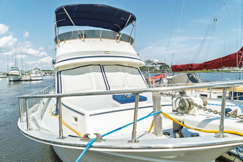 Slide: The Image of 1982 Albin 43 yacht docked in a marina under a clear blue sky. - 6