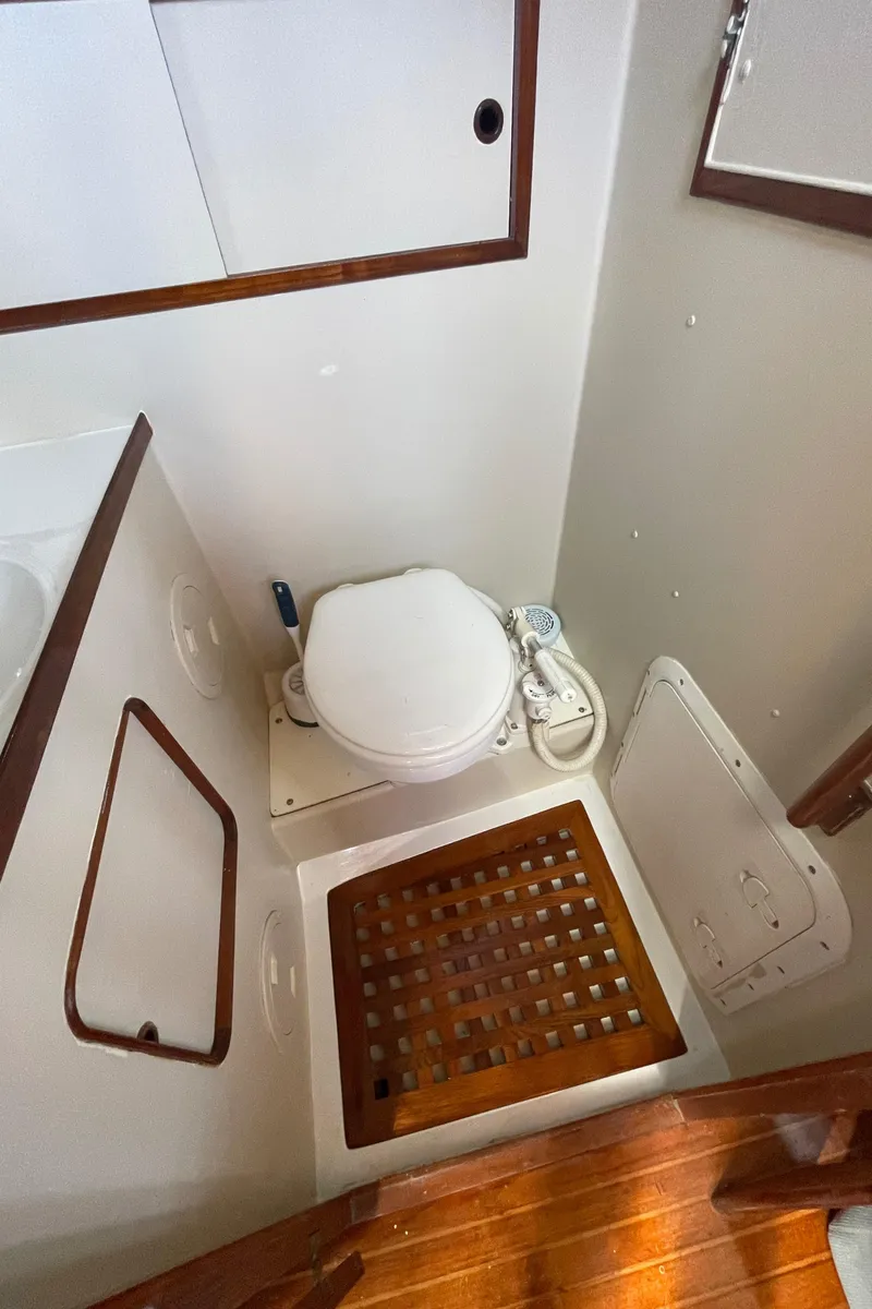 Slide: The Image of 1982 Albin 43 yacht bathroom with wooden flooring and compact toilet. - 65