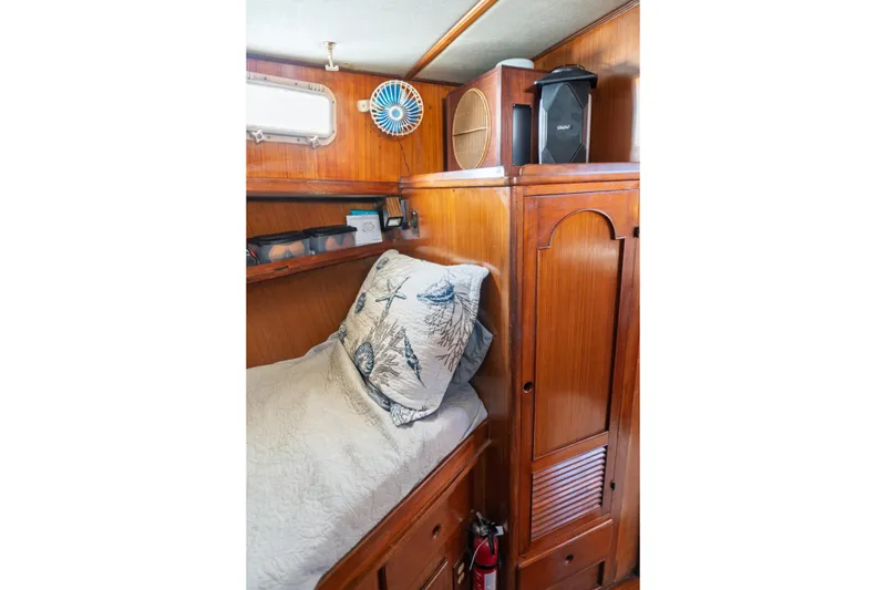 Slide: The Image of Cozy cabin interior of 1982 Albin 43 boat with wooden furnishings and nautical decor. - 69