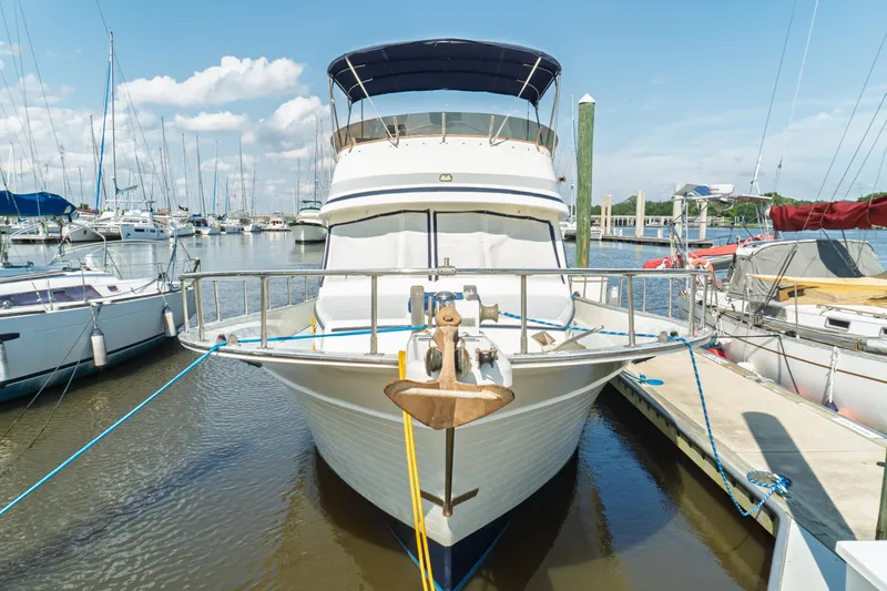 Slide: The Image of 1982 Albin 43 yacht docked at marina, surrounded by sailboats under a clear blue sky. - 7