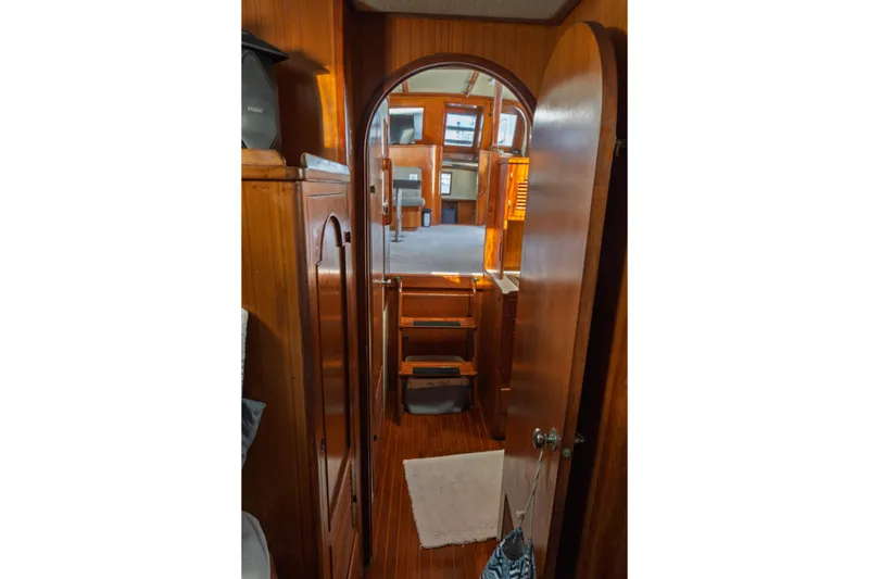 Slide: The Image of Interior view of 1982 Albin 43 yacht, featuring wooden cabinetry and cozy living space. - 70