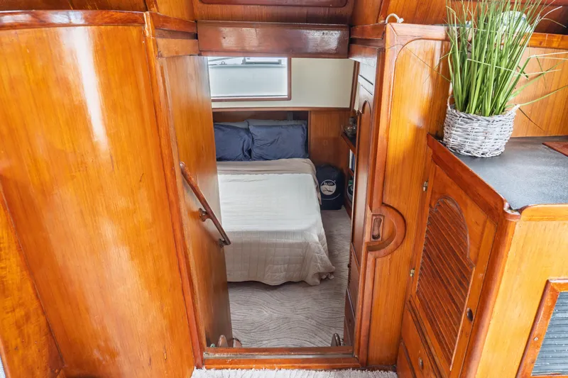 Slide: The Image of Cozy cabin interior of 1982 Albin 43 boat with wooden finish and bed. - 72