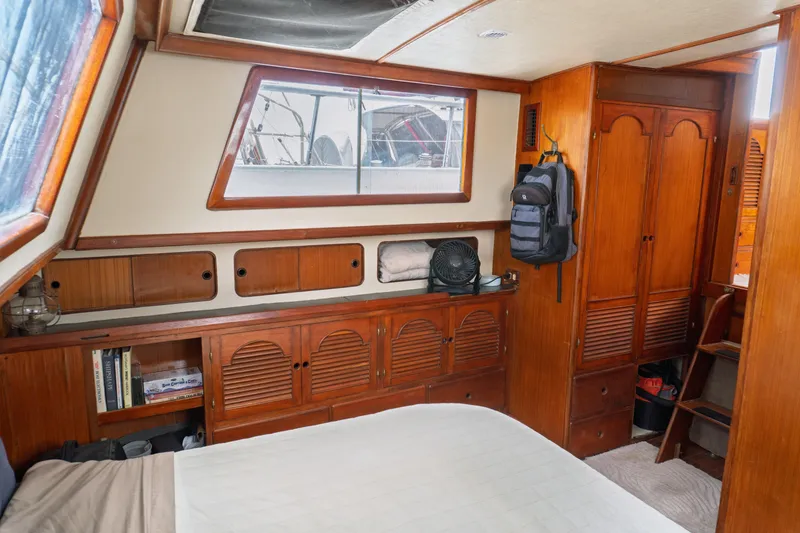 Slide: The Image of Interior of 1982 Albin 43 boat cabin with wooden furnishings and storage. - 75