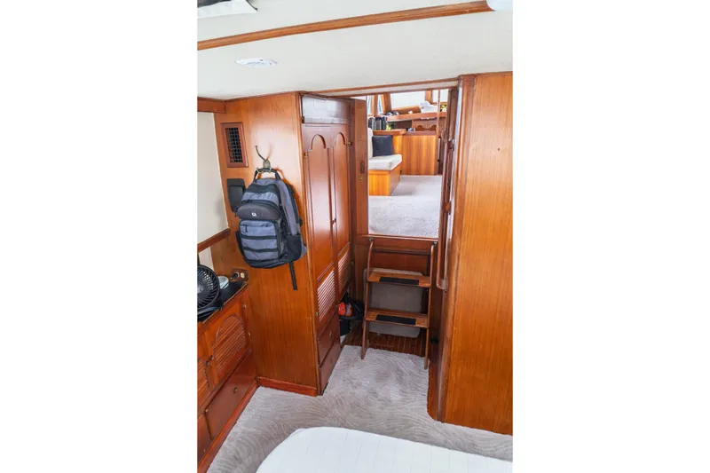 Slide: The Image of Interior of 1982 Albin 43 yacht with wooden cabinetry and compact staircase. - 76