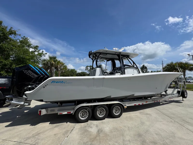 Slide: The Image of 2023 Front Runner 36 Center Console boat on trailer, featuring powerful outboard engine. - 12