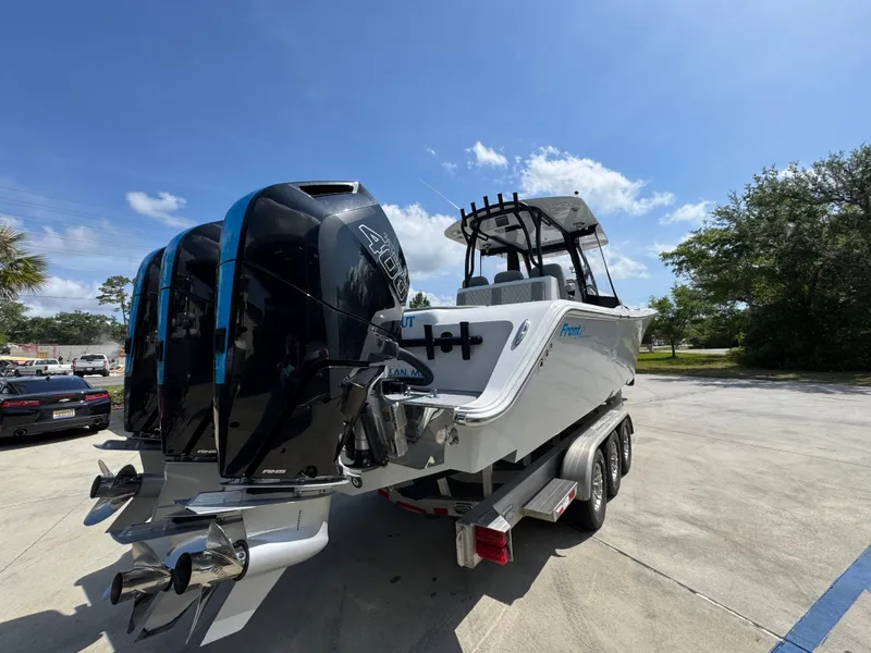 Slide: The Image of 2023 Front Runner 36 Center Console boat with triple outboard engines on a trailer. - 13
