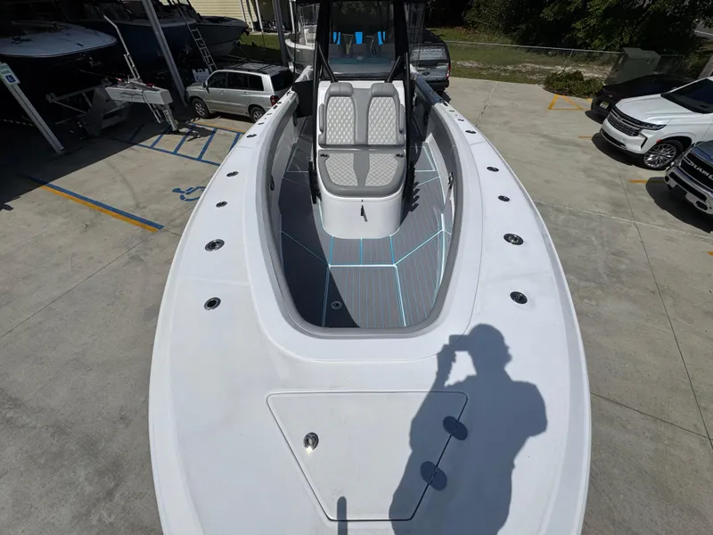 Slide: The Image of 2023 Front Runner 36 Center Console boat on trailer, featuring powerful outboard engine. - 18