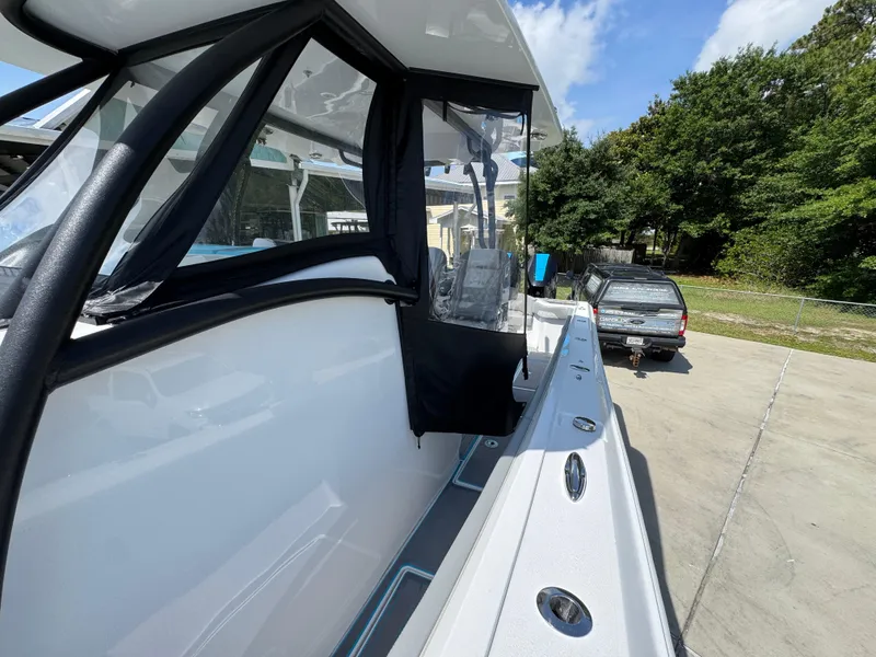 Slide: The Image of 2023 Front Runner 36 Center Console boat in a marina, showcasing sleek design and spacious deck. - 24