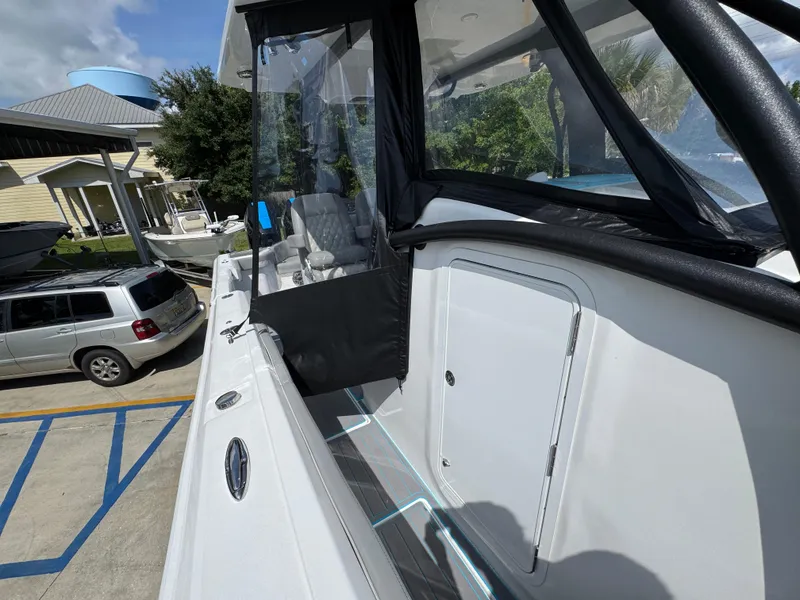 Slide: The Image of 2023 Front Runner 36 Center Console with Garmin equipment under a cloudy sky. - 25