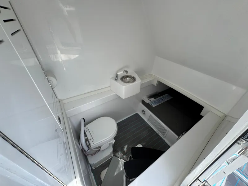 Slide: The Image of 2023 Front Runner 36 Center Console boat, sleek design, docked outdoors. - 27