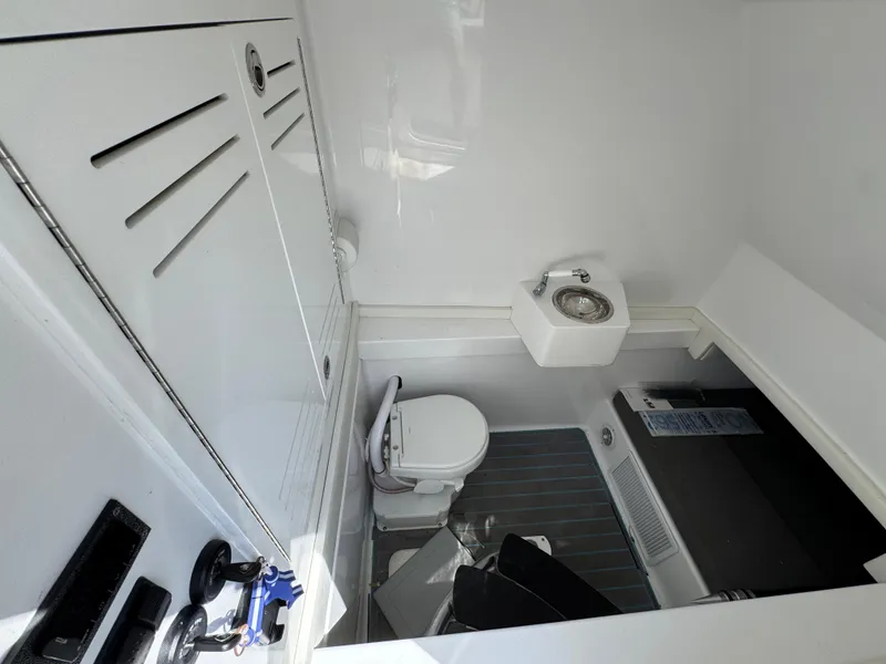 Slide: The Image of Interior of 2023 Front Runner 36 Center Console with control panel and marine toilet. - 28