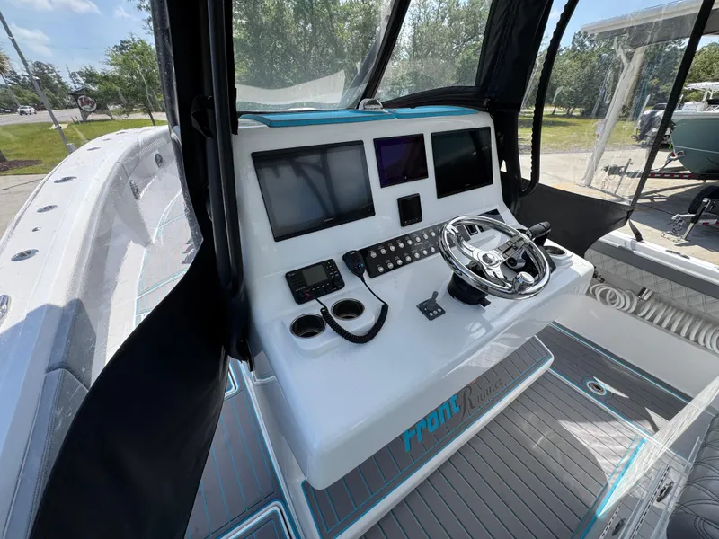 Slide: The Image of 2023 Front Runner 36 Center Console boat dashboard with Garmin displays and Mercury controls. - 31