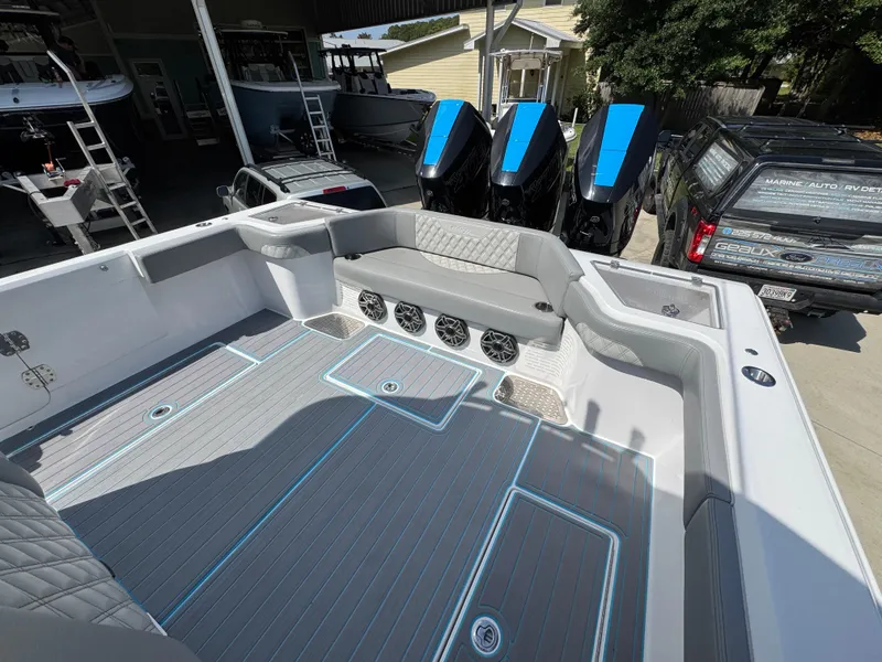 Slide: The Image of 2023 Front Runner 36 Center Console boat in a marina setting, showcasing sleek design and powerful engines. - 36