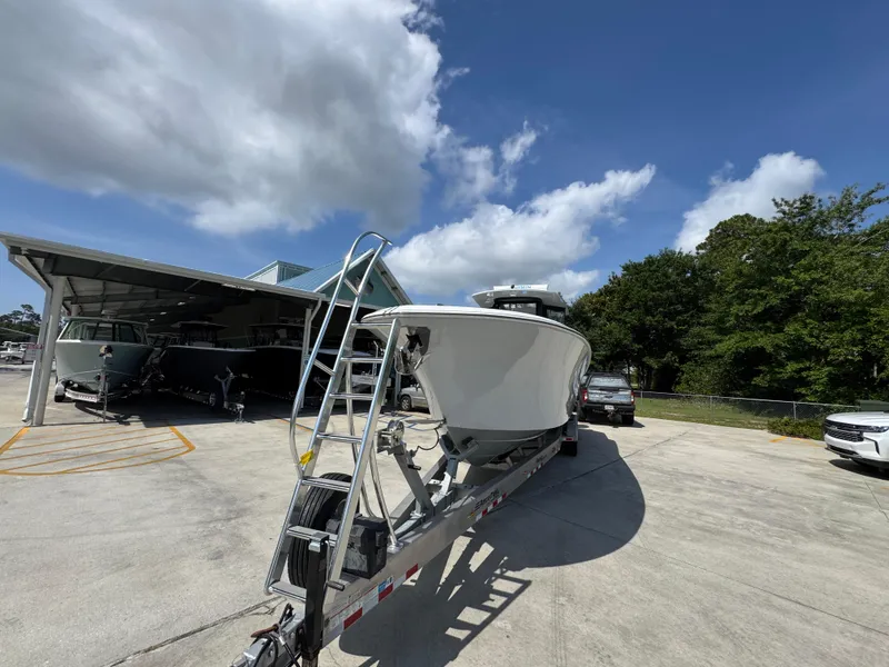 Slide: The Image of 2023 Front Runner 36 Center Console boat on trailer under cloudy sky. - 5