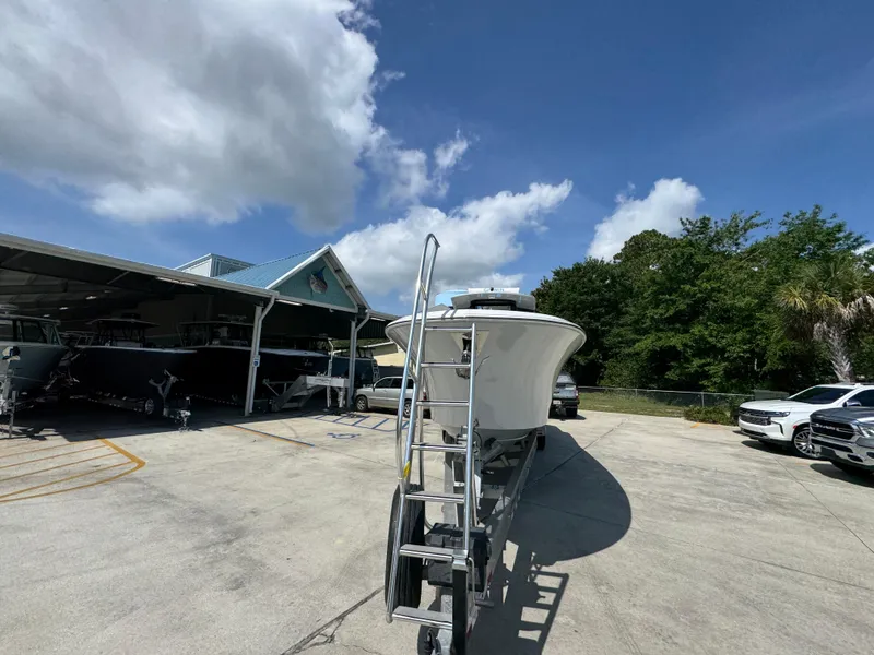 Slide: The Image of 2023 Front Runner 36 Center Console boat at a marina with cloudy sky. - 6