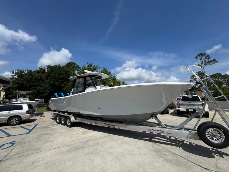 Slide: The Image of 2023 Front Runner 36 Center Console boat on trailer, parked outdoors under blue sky. - 9