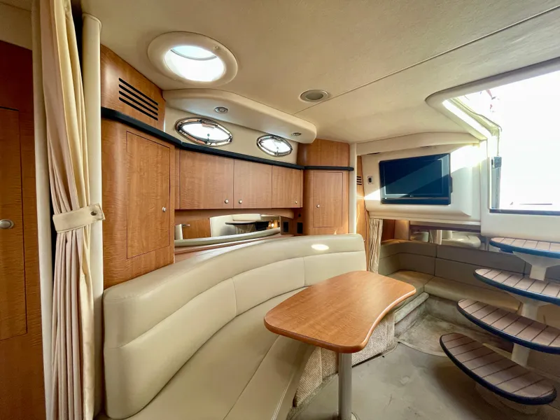 Slide: The Image of Interior of 2006 Sea Ray 320 Sundancer with seating, table, and TV. - 10