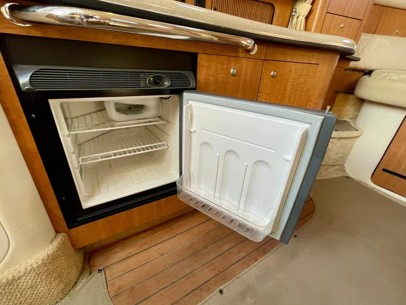 Slide: The Image of Open mini fridge in 2006 Sea Ray 320 Sundancer yacht interior. - 18