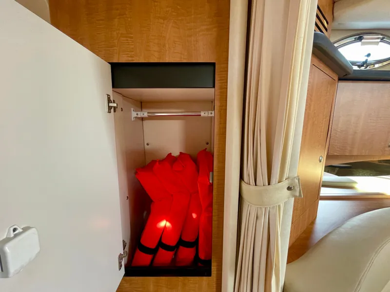 Slide: The Image of Open cabinet with life jackets on 2006 Sea Ray 320 Sundancer boat. - 20